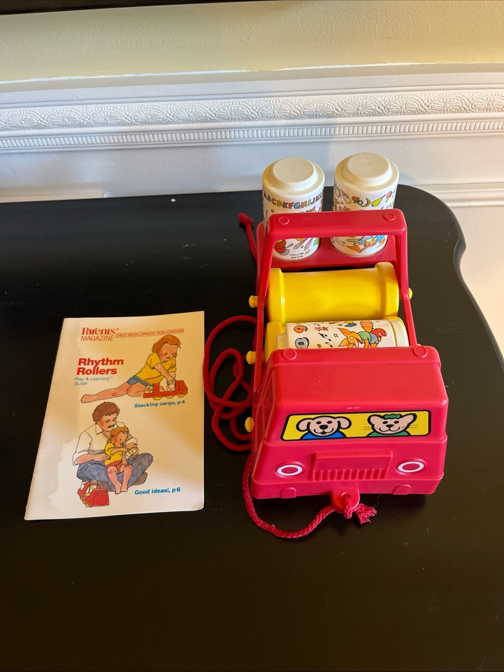 vintage parents magazine Rhythm Rollers red truck pull toy on rollers- mint